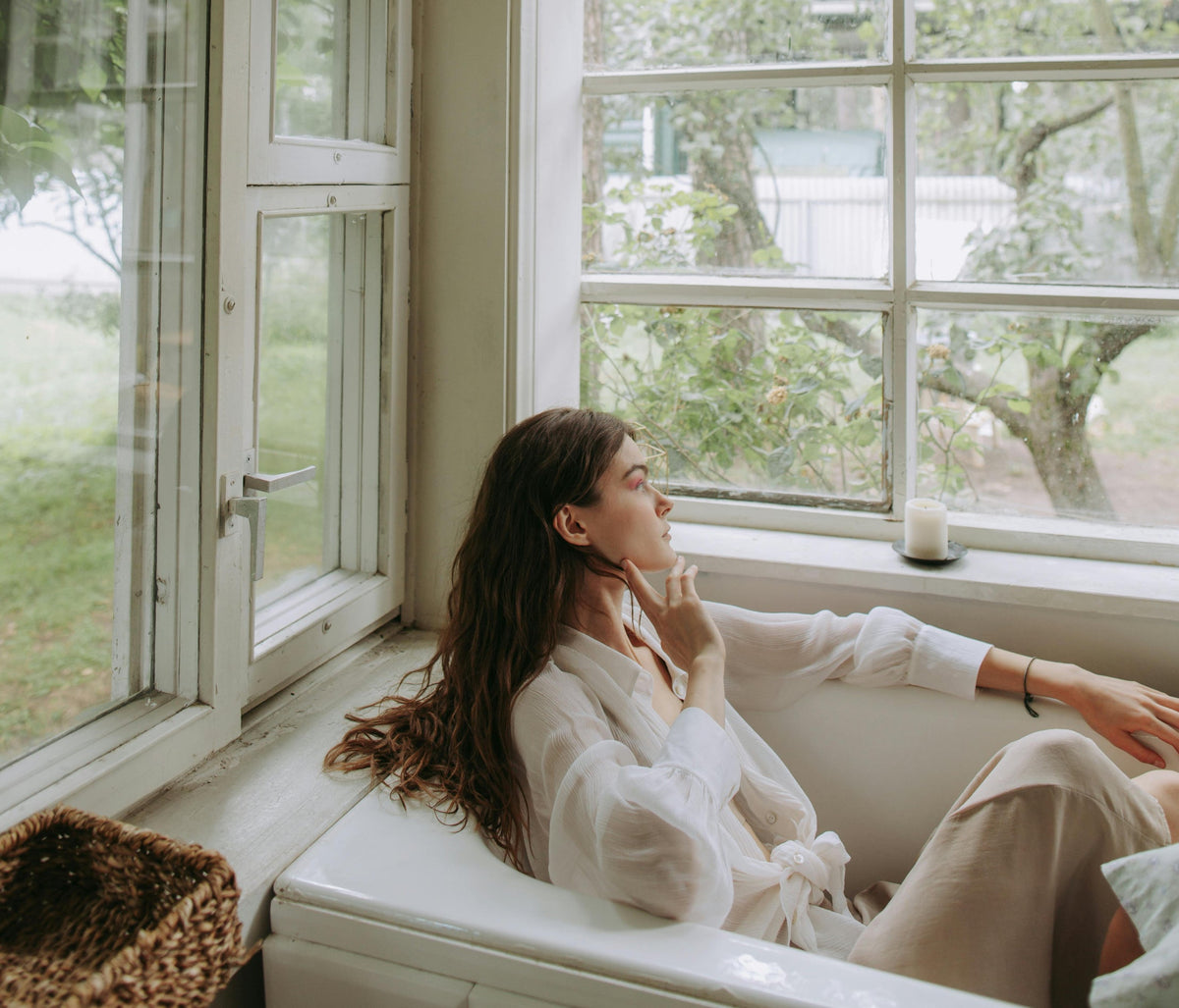 femme refléchissant et regardant à la fenêtre